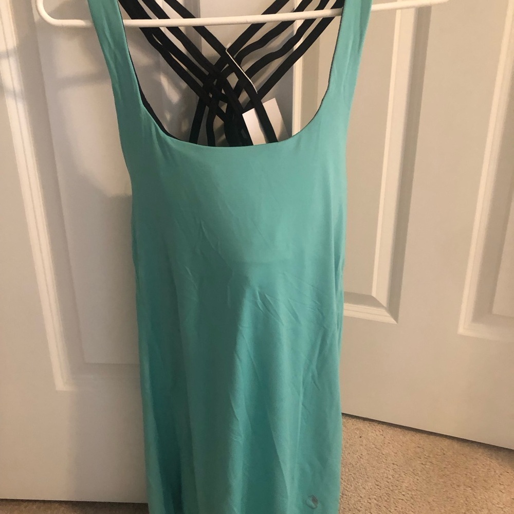 Long Teal workout top with Black sports bra attached.  Very unique. Draped back